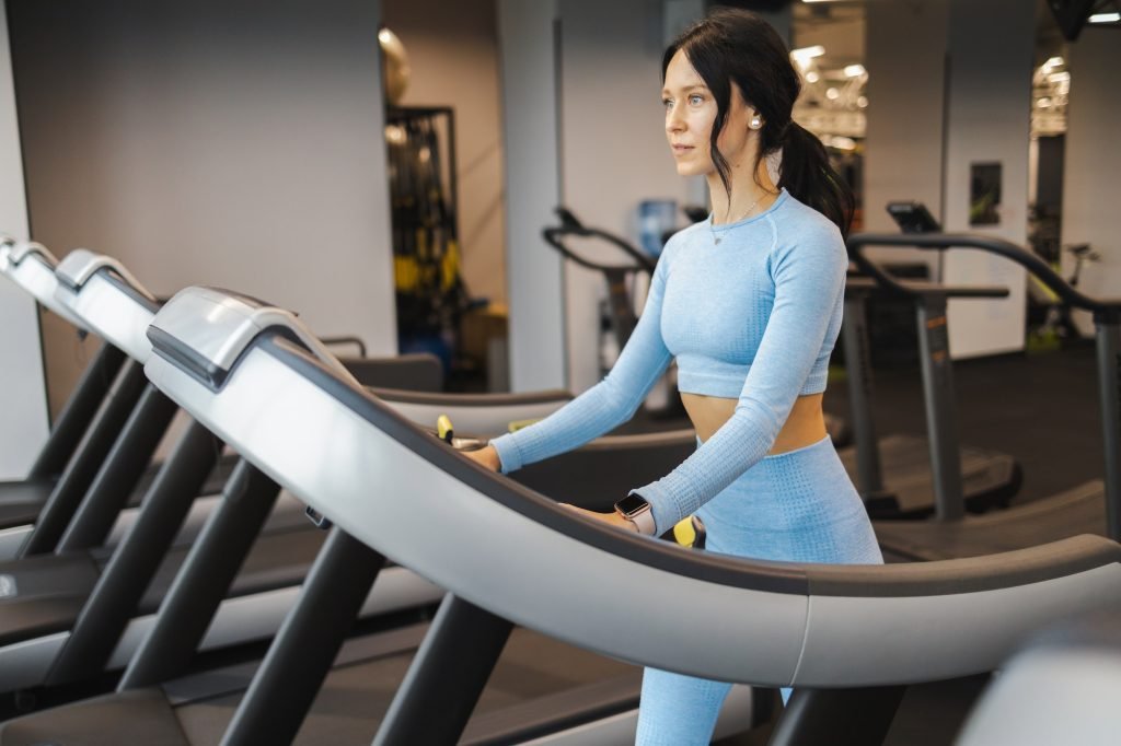 Fitness woman walking on a treadmill
