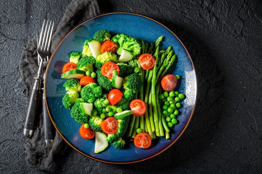 Healthy salad made of cherry tomatoes, asparagus and broccoli