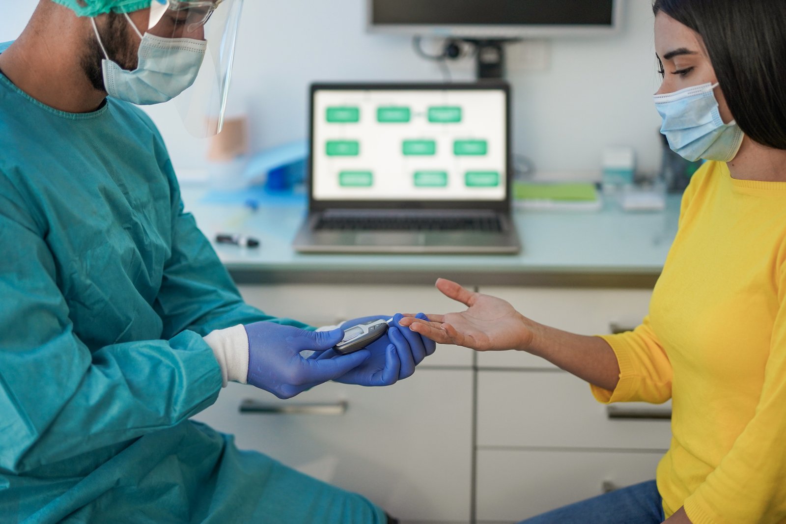 Doctor making blood sugar test to a young woman in medical clinic for diabetes