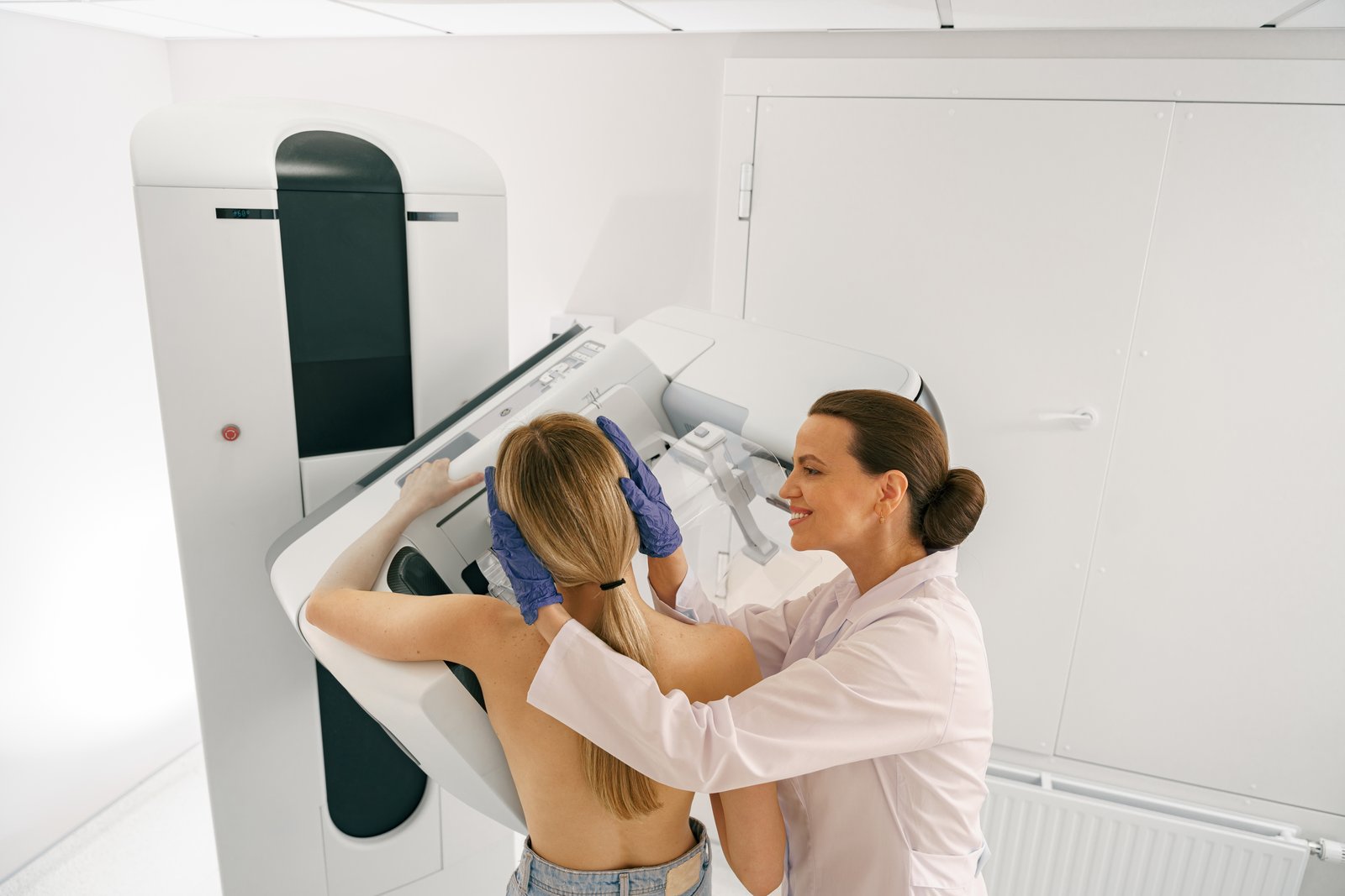 Female radiologist doing mammogram x ray for young woman to check for breast cancer