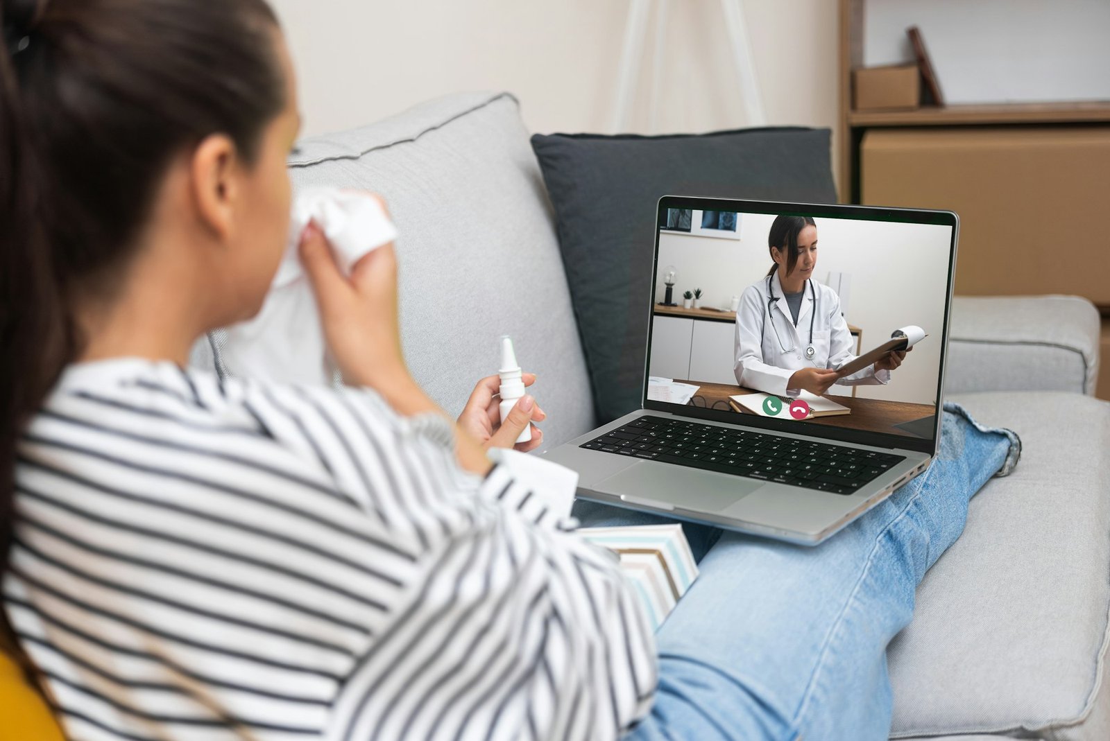 Doctor on laptop screen discussing medical reports with a patient during a telehealth appointment